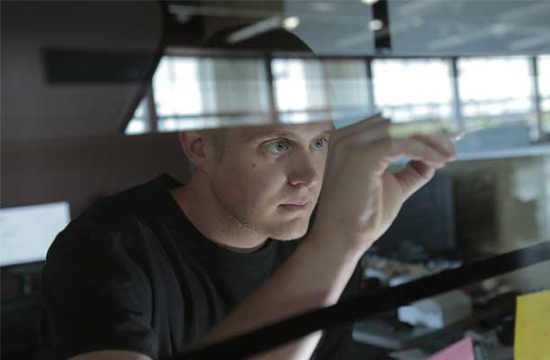 Man Analyzing Information on a Glass Screen