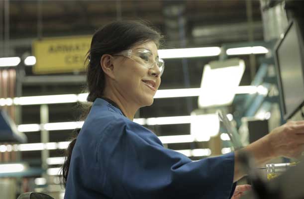 Woodward Member Smiling While Working