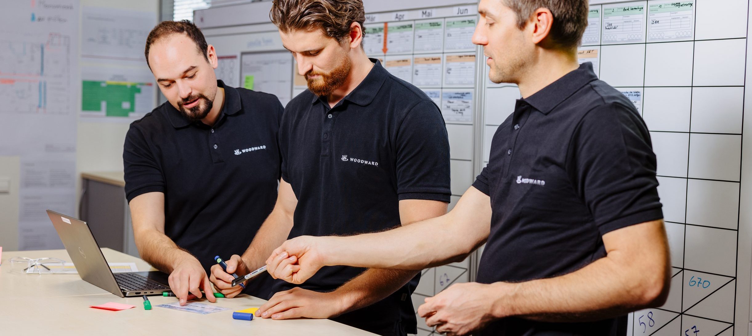 Three Woodward Members working to problem-solve