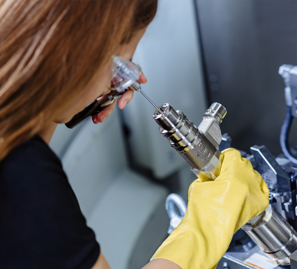 Woman working on a Woodward Product in a manufacturing setting